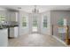 Bright dining area with tile flooring, white walls, and windows overlooking the backyard at 237 River Pass Ct, Dacula, GA 30019