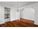 Light-filled dining room featuring hardwood floors, chandelier, and wainscoting details at 237 River Pass Ct, Dacula, GA 30019