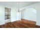 Elegant dining room featuring a chandelier, hardwood floors, and views into the kitchen at 237 River Pass Ct, Dacula, GA 30019