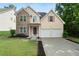 Charming two-story home boasts a stone facade, two-car garage, and well-manicured front yard at 237 River Pass Ct, Dacula, GA 30019