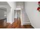 Bright foyer features hardwood floors, a staircase with white railings, and high ceilings at 237 River Pass Ct, Dacula, GA 30019