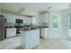 Well-lit kitchen with central island, tiled floor, stainless steel appliances, and plenty of storage at 237 River Pass Ct, Dacula, GA 30019