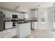 Spacious kitchen with white cabinets, stainless steel appliances, and a central island at 237 River Pass Ct, Dacula, GA 30019