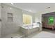Beautiful bathroom with tiled shower, soaking tub, and an entrance view of the bedroom at 3153 Daleview Sw Way, Atlanta, GA 30331