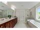 Large bathroom with dual sinks, walk-in shower, soaking tub and white marble floors at 3153 Daleview Sw Way, Atlanta, GA 30331