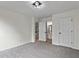 Spacious bedroom with neutral carpet and doorway views of a bathroom and hallway at 3153 Daleview Sw Way, Atlanta, GA 30331