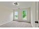 Cozy bedroom featuring neutral carpet, trim and paint with natural light from the dual windows at 3153 Daleview Sw Way, Atlanta, GA 30331