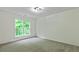 Bedroom featuring neutral carpet, trim and paint with large window and views of the outdoors at 3153 Daleview Sw Way, Atlanta, GA 30331