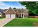 Traditional brick two-story home with a well-manicured lawn and two-car garage at 3153 Daleview Sw Way, Atlanta, GA 30331