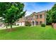 Charming two-story brick home with three-car garage, lush lawn, and mature trees at 3153 Daleview Sw Way, Atlanta, GA 30331