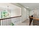 Upstairs hallway with wood and iron banister, large arched window and modern chandelier at 3153 Daleview Sw Way, Atlanta, GA 30331