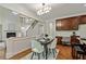 View of the eat-in kitchen with wood floors, a dining table, and access to the living room and staircase at 3153 Daleview Sw Way, Atlanta, GA 30331