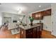 Open kitchen with island, granite countertops, and stainless appliances flows into the breakfast area and living room at 3153 Daleview Sw Way, Atlanta, GA 30331