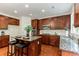 Kitchen featuring a center island with seating, stainless steel appliances, and dark wooden cabinets at 3153 Daleview Sw Way, Atlanta, GA 30331