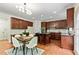 Bright kitchen featuring wooden cabinets, a center island with bar stools, and an eat-in dining area at 3153 Daleview Sw Way, Atlanta, GA 30331