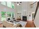 Bright living room with fireplace, staircase, and large windows offering natural light and outside views at 3153 Daleview Sw Way, Atlanta, GA 30331