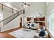 Open-concept living room with a staircase, and access to the kitchen and large windows at 3153 Daleview Sw Way, Atlanta, GA 30331