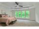 Main bedroom features a tray ceiling, ceiling fan, and large windows offering natural light at 3153 Daleview Sw Way, Atlanta, GA 30331