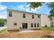 A home's backyard featuring a tan exterior, a sliding glass door and a small patio at 411 Sugar Maple Ct, Canton, GA 30114