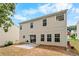 Backyard with tan siding, patio, sliding glass door, and shade trees at 411 Sugar Maple Ct, Canton, GA 30114