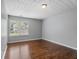 Empty bedroom with wood floors, neutral walls, and a bright window view at 411 Sugar Maple Ct, Canton, GA 30114