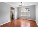 Dining room showcasing hardwood flooring, a modern chandelier, and access to the kitchen at 411 Sugar Maple Ct, Canton, GA 30114