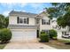 Charming two-story home features a two-car garage and well-maintained landscaping at 411 Sugar Maple Ct, Canton, GA 30114