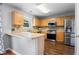 Bright kitchen showcasing stainless steel appliances, wooden cabinets, and a light-colored countertop at 411 Sugar Maple Ct, Canton, GA 30114