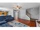 Living room with hardwood floors, a ceiling fan, and staircase access to the upper level at 411 Sugar Maple Ct, Canton, GA 30114