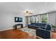 Bright and open living room with a comfortable sectional sofa and hardwood flooring at 411 Sugar Maple Ct, Canton, GA 30114