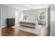 Bright main bedroom features hardwood floors and large windows with serene outdoor views at 411 Sugar Maple Ct, Canton, GA 30114