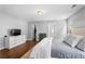 Main bedroom featuring hardwood flooring, neutral walls, and walk in closet at 411 Sugar Maple Ct, Canton, GA 30114