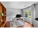 Inviting office with hardwood floors, a large window, and a white desk at 411 Sugar Maple Ct, Canton, GA 30114