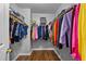 Organized walk-in closet with shelving and ample storage space for clothing at 411 Sugar Maple Ct, Canton, GA 30114