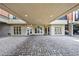 Covered entrance with stone tile flooring and glass doorways leading into a modern building at 560 Dutch Valley Ne Rd # 2207, Atlanta, GA 30324