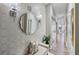 Elegant hallway design featuring a decorative mirror, stylish sconces, and patterned wallpaper at 560 Dutch Valley Ne Rd # 2207, Atlanta, GA 30324