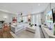 Bright living room with comfortable white sectional, large windows, and stylish decorations at 560 Dutch Valley Ne Rd # 2207, Atlanta, GA 30324