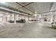 Spacious parking garage with ample spaces, high ceilings, and visible piping and infrastructure at 560 Dutch Valley Ne Rd # 2207, Atlanta, GA 30324