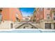 Inviting outdoor pool between brick buildings, accessible by metal stairs, offering a peaceful retreat at 560 Dutch Valley Ne Rd # 2207, Atlanta, GA 30324