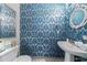 Stylish powder room featuring blue damask wallpaper, a pedestal sink, and a decorative mirror, creating a chic ambiance at 560 Dutch Valley Ne Rd # 2207, Atlanta, GA 30324