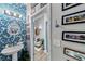 Elegant powder room with a pedestal sink, blue damask wallpaper and a stylish mirror, creating a classic look at 560 Dutch Valley Ne Rd # 2207, Atlanta, GA 30324