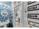 Elegant powder room featuring a pedestal sink, eye-catching wallpaper, and stylish decor, creating a welcoming space at 560 Dutch Valley Ne Rd # 2207, Atlanta, GA 30324
