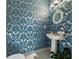 Elegant powder room with striking blue and gold damask wallpaper, a pedestal sink, and sophisticated lighting at 560 Dutch Valley Ne Rd # 2207, Atlanta, GA 30324