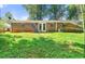 Expansive backyard with a brick patio and lush green lawn, perfect for outdoor living and entertaining at 2830 Knollview Dr, Decatur, GA 30034