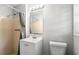 Cozy bathroom with a shower, modern vanity, and a well-lit mirror over a white sink and toilet at 2830 Knollview Dr, Decatur, GA 30034