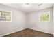 Bedroom with neutral walls, carpet flooring, and two windows at 2830 Knollview Dr, Decatur, GA 30034