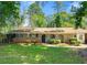 Front exterior showcasing the home's brick facade, arched doorways, and landscaped front yard at 2830 Knollview Dr, Decatur, GA 30034
