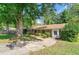 Charming single-story home featuring a brick facade, arched doorways, and mature trees at 2830 Knollview Dr, Decatur, GA 30034