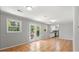 Open-concept living area with tile floors, white walls, and a view of the backyard through French doors at 2830 Knollview Dr, Decatur, GA 30034