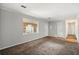 Bright living room featuring neutral paint, carpet floors, and natural light from a large window at 2830 Knollview Dr, Decatur, GA 30034